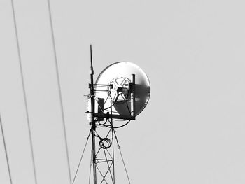 Low angle view of electricity pylon against clear sky