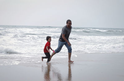 Full length of man on beach against sky