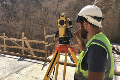 Side view of young man at construction site