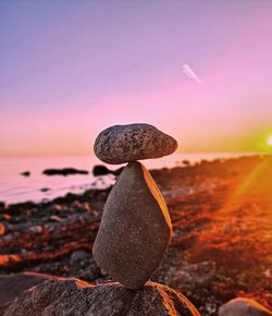 Stacked rocks with a beautiful shiny sunset in the background 