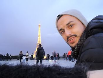 People in snow against sky during winter