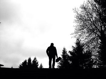 Silhouette of people standing against sky