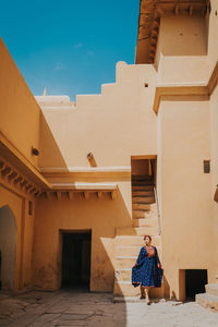 Woman standing outside building