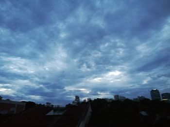 Low angle view of silhouette buildings against sky