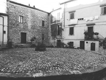 Empty street amidst buildings in town