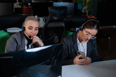 Side view of business colleagues working in office