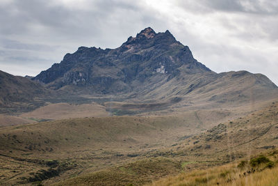 Scenic view of mountains against cloudy sky