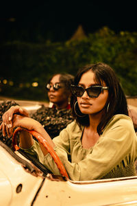 Portrait of young women sitting in car