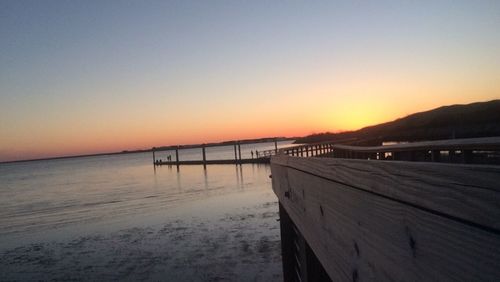 Pier on sea at sunset