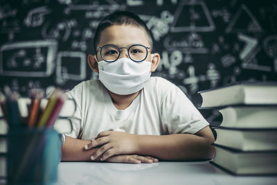 Portrait of boy sitting on table