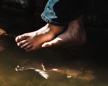 Low section of woman legs in lake