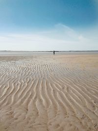 Scenic view of sandy beach against sky