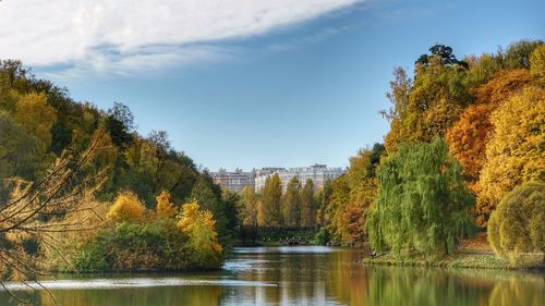 Scenic view of lake by trees against sky during autumn