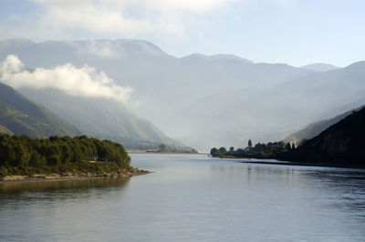 Scenic view of lake and mountains against sky