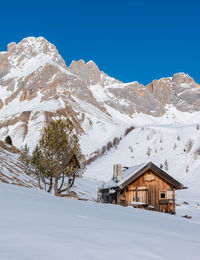 Scenic view of snowcapped mountains against clear blue sky