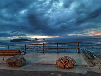 Scenic view of sea against storm clouds