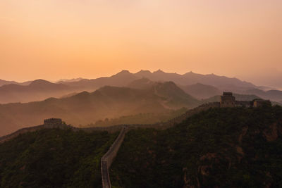 The view of the mountains and the great wall at sunset