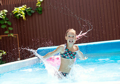 Young woman swimming in pool