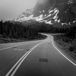 Road by mountain against sky