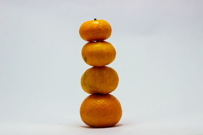 Close-up of oranges against white background