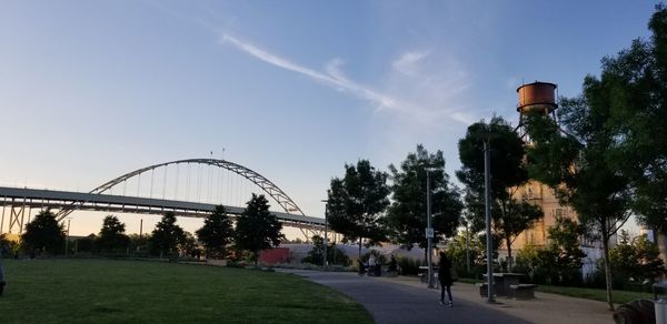 People on street in park against sky