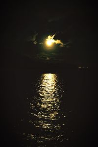 Scenic view of lake against sky at night