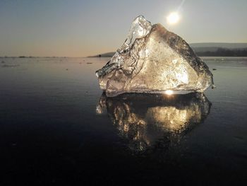 Reflection of ice chunk against sky