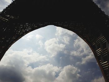 Low angle view of bridge against cloudy sky