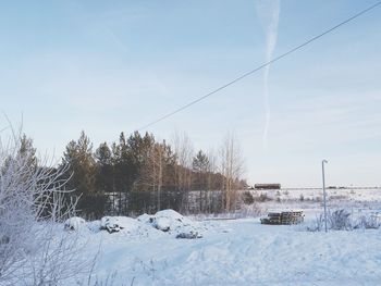 Snow covered landscape against sky