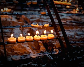 Close-up of illuminated candles at church