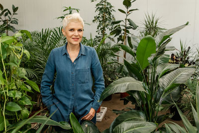 Portrait of woman. gardening at home. retired female care for her plant.