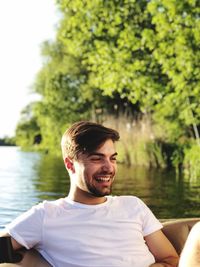 Portrait of young man against lake