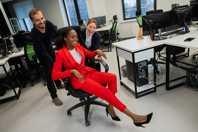 Side view of woman using laptop at office