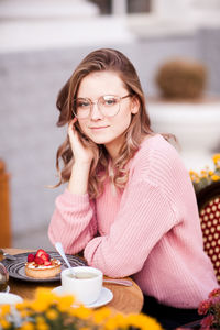 Portrait of teenager girl sitting at restaurant
