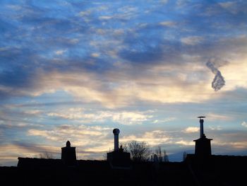 Silhouette of building against dramatic sky