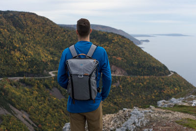 Rear view of man standing on mountain