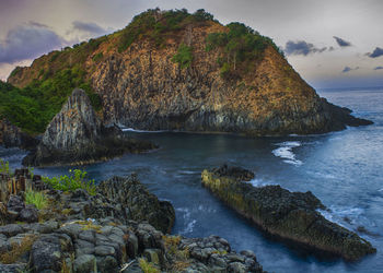 Scenic view of sea and rocks against sky