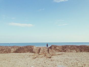 Scenic view beach against blue sky