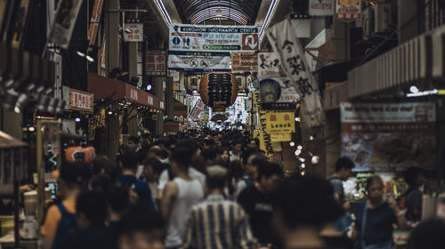 People on street amidst buildings in city