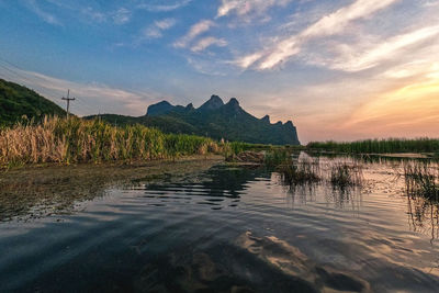 Scenic view of lake against sky during sunset