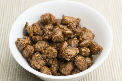 High angle view of roasted almonds in bowl on table