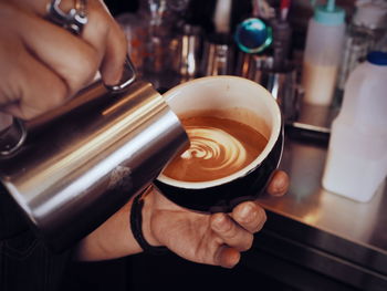 Close-up of hand holding coffee cup