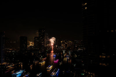 High angle view of illuminated buildings in city at night