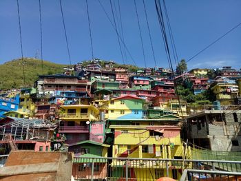 Residential buildings against clear blue sky