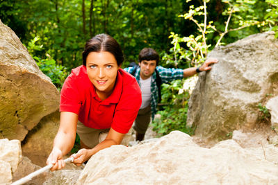Portrait of young couple standing on cliff