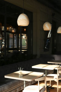 Illuminated electric lamp on table in restaurant