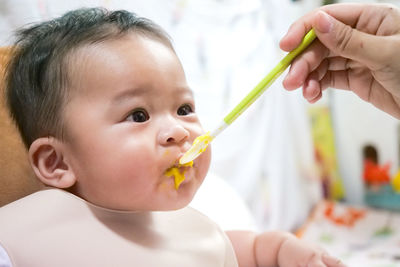 Portrait of baby boy eating food