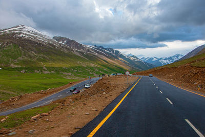 Road amidst mountains against sky