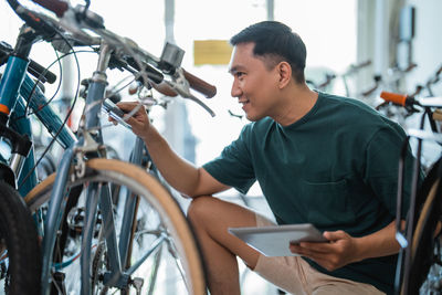 Side view of man riding bicycle