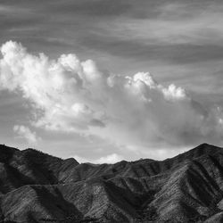 Scenic view of mountains against cloudy sky